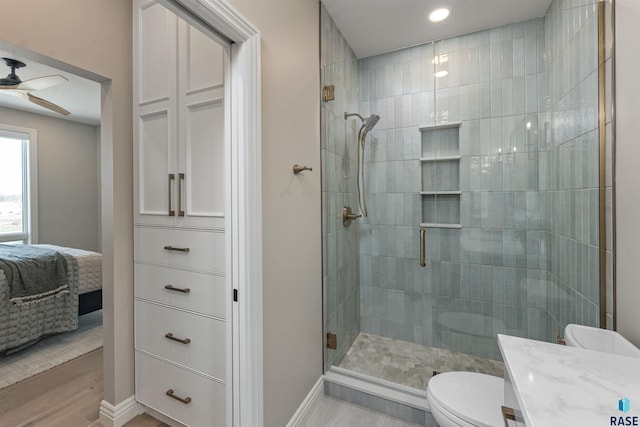 2720 S Oriya Pl, Sioux Falls, SD 57106 - bathroom with ensuite bathroom, a shower stall, toilet, a ceiling fan, and baseboards