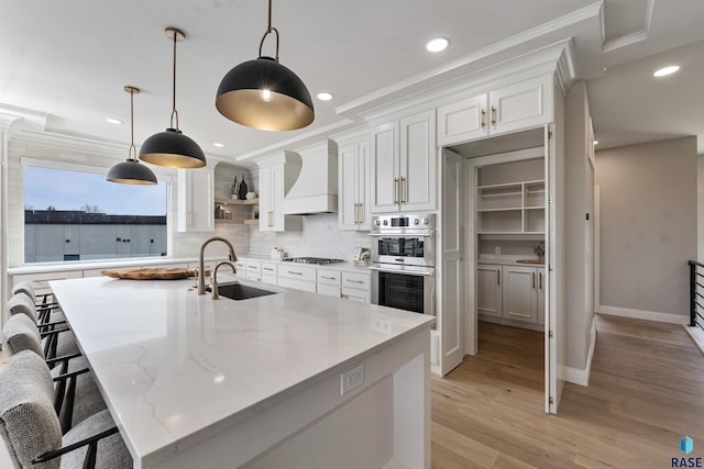 2720 S Oriya Pl, Sioux Falls, SD 57106 - kitchen with custom exhaust hood, open shelves, a sink, white cabinets, and ornamental molding