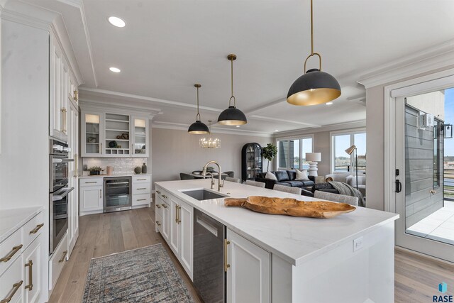 2720 S Oriya Pl, Sioux Falls, SD 57106 - kitchen featuring a sink, wine cooler, stainless steel appliances, white cabinetry, and light wood-style flooring