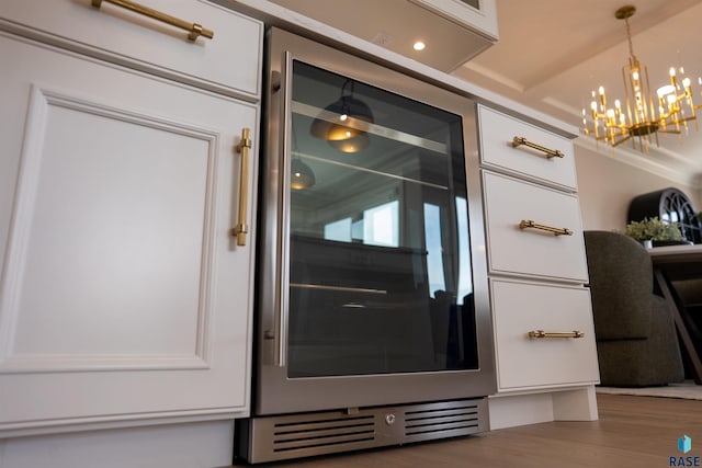 2720 S Oriya Pl, Sioux Falls, SD 57106 - detailed view of beverage cooler, wood finished floors, and a chandelier