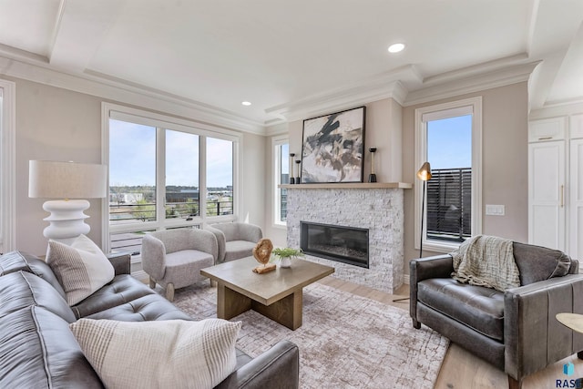 2720 S Oriya Pl, Sioux Falls, SD 57106 - living area featuring crown molding, a stone fireplace, wood finished floors, and recessed lighting