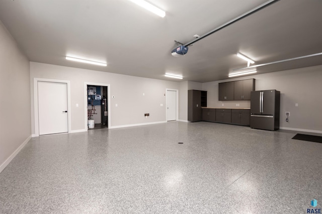 2720 S Oriya Pl, Sioux Falls, SD 57106 - garage with freestanding refrigerator, a garage door opener, baseboards, and water heater