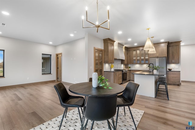 7309 E Shadow Pine Cir, Sioux Falls, SD 57110 - dining area featuring light wood-type flooring, recessed lighting, a chandelier, and baseboards