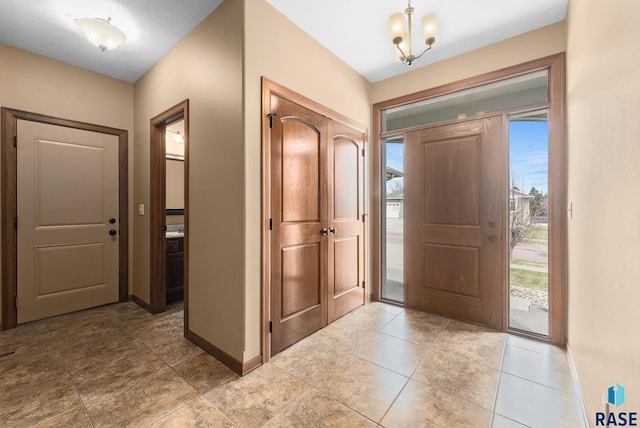 7005 E Archstone St, Sioux Falls, SD 57110 - foyer entrance featuring baseboards and a chandelier