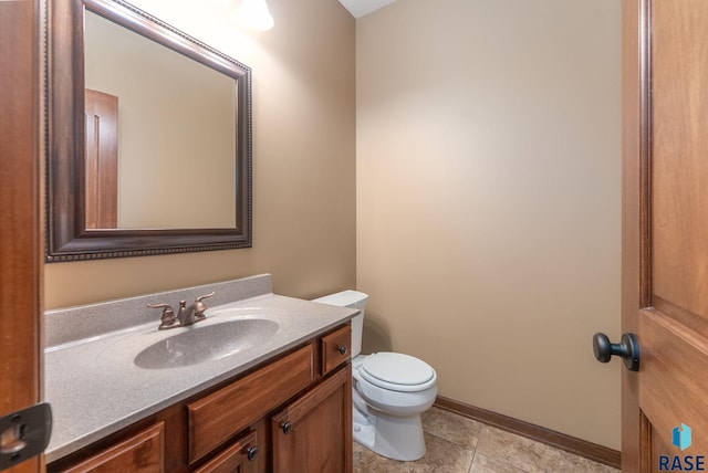 7005 E Archstone St, Sioux Falls, SD 57110 - half bathroom with vanity, toilet, baseboards, and tile patterned flooring