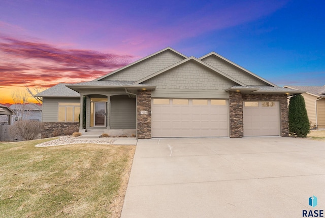 7005 E Archstone St, Sioux Falls, SD 57110 - view of front of home featuring a garage, driveway, and stone siding