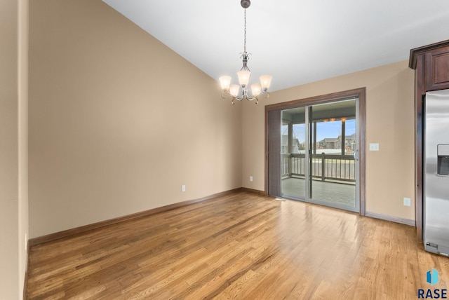 7005 E Archstone St, Sioux Falls, SD 57110 - spare room with light wood-style flooring, a chandelier, baseboards, and lofted ceiling