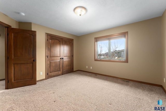 7005 E Archstone St, Sioux Falls, SD 57110 - unfurnished bedroom featuring a closet, baseboards, and carpet floors