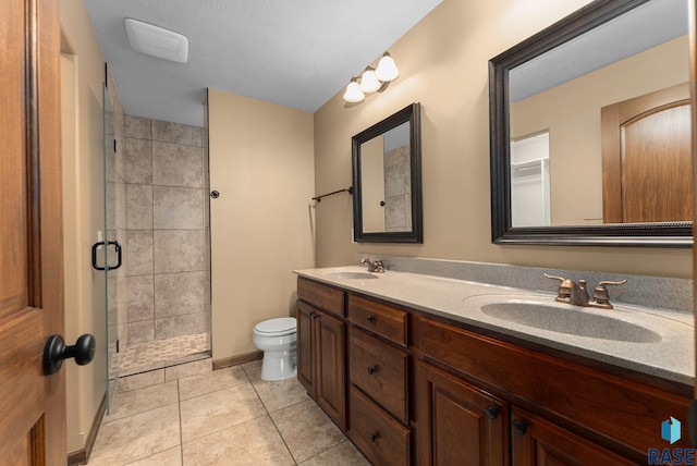7005 E Archstone St, Sioux Falls, SD 57110 - full bathroom featuring double vanity, a shower stall, toilet, and tile patterned flooring