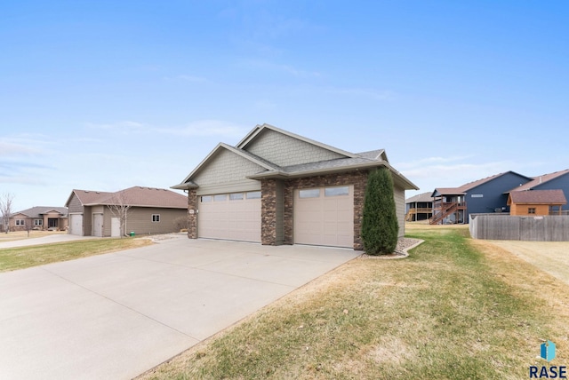 7005 E Archstone St, Sioux Falls, SD 57110 - view of front facade featuring stone siding, concrete driveway, and a garage