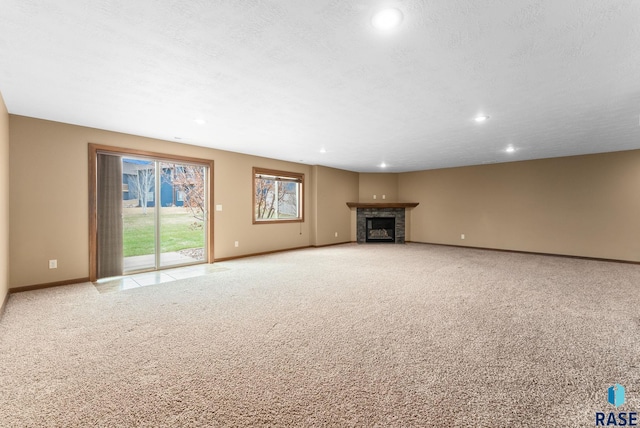 7005 E Archstone St, Sioux Falls, SD 57110 - unfurnished living room with baseboards, recessed lighting, light carpet, and a fireplace