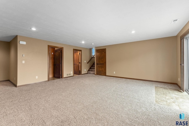 7005 E Archstone St, Sioux Falls, SD 57110 - unfurnished room featuring light colored carpet, stairs, recessed lighting, and baseboards