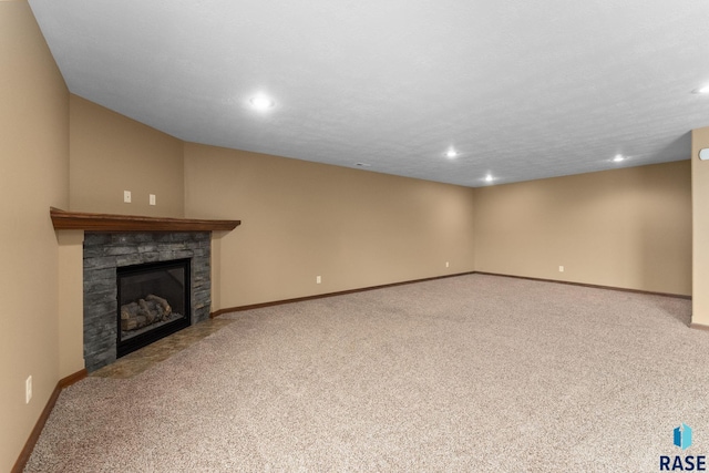 7005 E Archstone St, Sioux Falls, SD 57110 - unfurnished living room with carpet flooring, recessed lighting, baseboards, and a stone fireplace