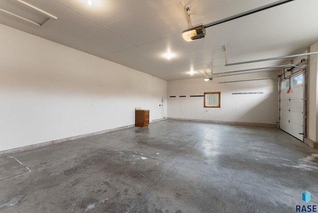 7005 E Archstone St, Sioux Falls, SD 57110 - garage featuring a garage door opener and baseboards