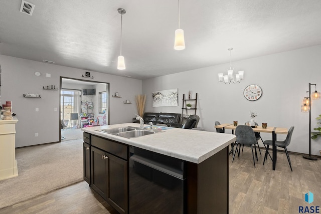 2554 E Meadowside Pl, Sioux Falls, SD 57108 - kitchen featuring a sink, dishwashing machine, light wood-type flooring, light countertops, and a chandelier