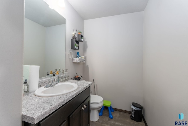 2554 E Meadowside Pl, Sioux Falls, SD 57108 - bathroom with wood finished floors, toilet, vanity, and baseboards