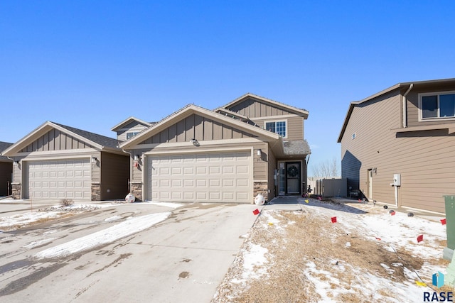 2554 E Meadowside Pl, Sioux Falls, SD 57108 - view of front facade featuring board and batten siding, stone siding, an attached garage, and concrete driveway