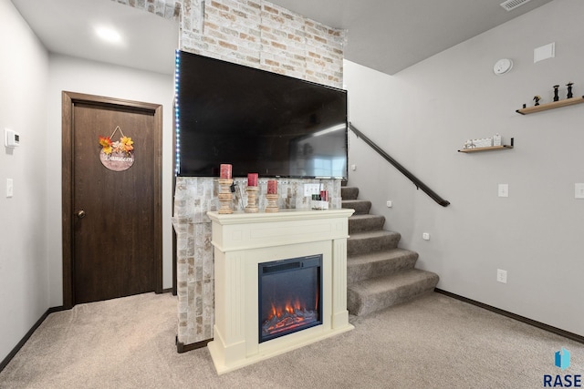 2554 E Meadowside Pl, Sioux Falls, SD 57108 - carpeted living area featuring stairs, baseboards, and a glass covered fireplace