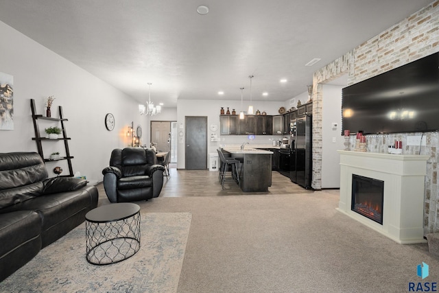 2554 E Meadowside Pl, Sioux Falls, SD 57108 - living room with a chandelier, light colored carpet, a glass covered fireplace, and recessed lighting