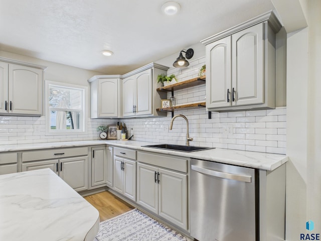 577 60th Ave, Beaver Creek, MN 56116 - kitchen featuring stainless steel dishwasher, a sink, light wood-style flooring, and tasteful backsplash