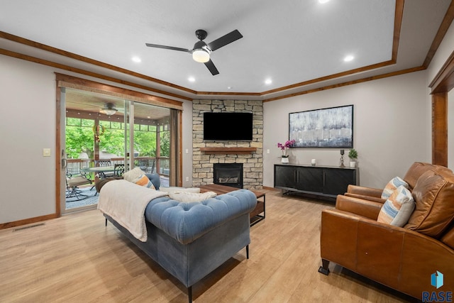 1325 W Whitechurch Ln, Sioux Falls, SD 57108 - living room with a ceiling fan, light wood-style floors, a stone fireplace, ornamental molding, and baseboards