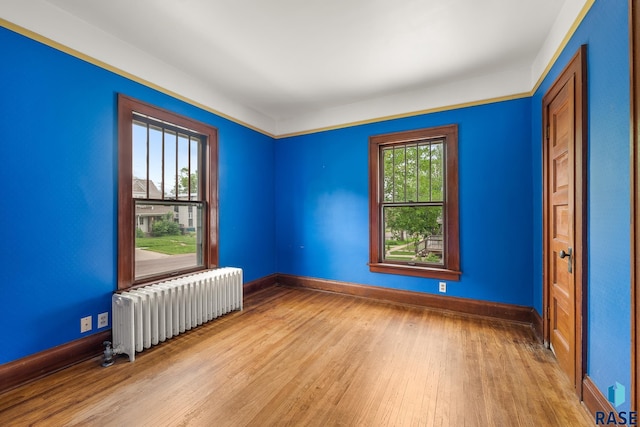 302 E 19th St, Sioux Falls, SD 57105 - empty room with radiator, wood finished floors, and baseboards