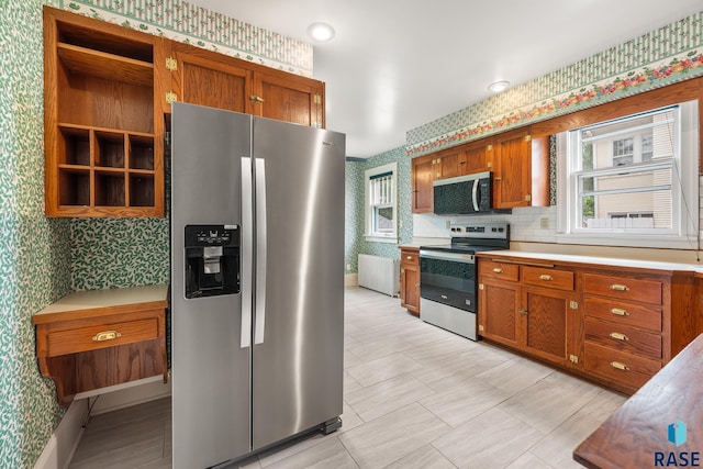 302 E 19th St, Sioux Falls, SD 57105 - kitchen featuring appliances with stainless steel finishes, wallpapered walls, brown cabinetry, light countertops, and open shelves