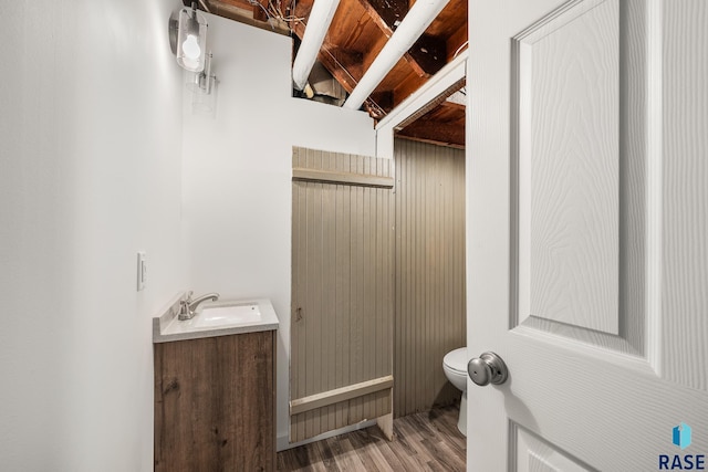 302 E 19th St, Sioux Falls, SD 57105 - half bathroom with toilet, vanity, and wood finished floors