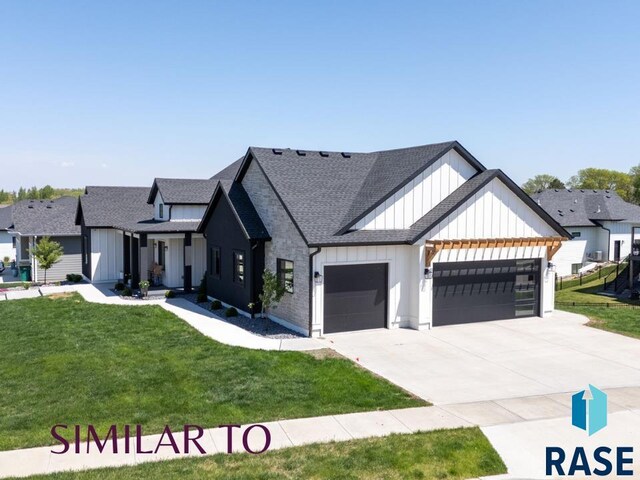 1112 N Slate Ave, Brandon, SD 57005 - modern farmhouse style home with board and batten siding, an attached garage, a front yard, roof with shingles, and driveway