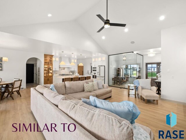 1112 N Slate Ave, Brandon, SD 57005 - living area featuring arched walkways, high vaulted ceiling, ceiling fan, light wood finished floors, and recessed lighting