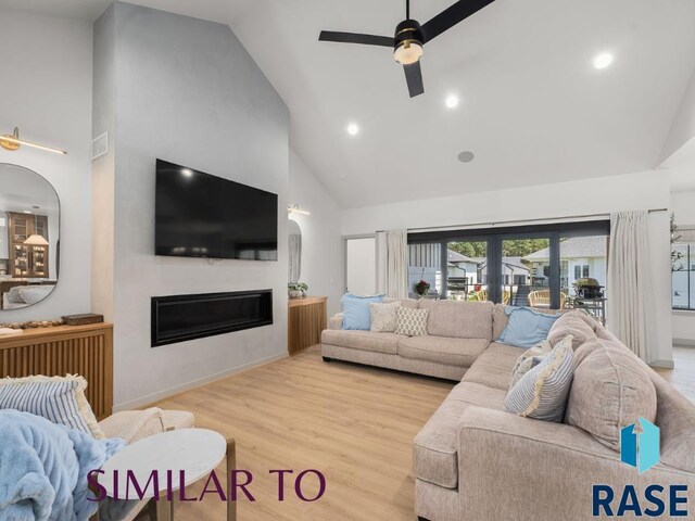 1112 N Slate Ave, Brandon, SD 57005 - living area with high vaulted ceiling, a ceiling fan, a glass covered fireplace, wood finished floors, and recessed lighting