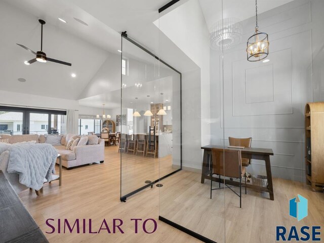 1112 N Slate Ave, Brandon, SD 57005 - living room with high vaulted ceiling, a chandelier, wood finished floors, and a ceiling fan