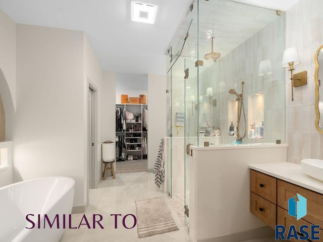 1112 N Slate Ave, Brandon, SD 57005 - full bath featuring a stall shower, a freestanding bath, a spacious closet, and vanity