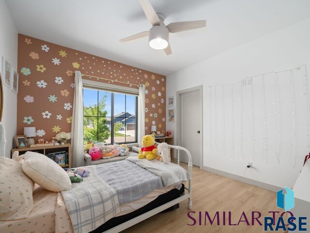 1112 N Slate Ave, Brandon, SD 57005 - bedroom featuring wallpapered walls, light wood-style flooring, and ceiling fan