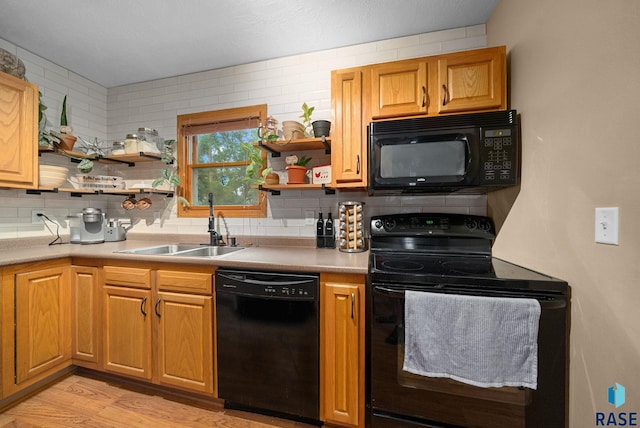 308 W 5th Ave, Lennox, SD 57039 - kitchen with black appliances, open shelves, a sink, and decorative backsplash