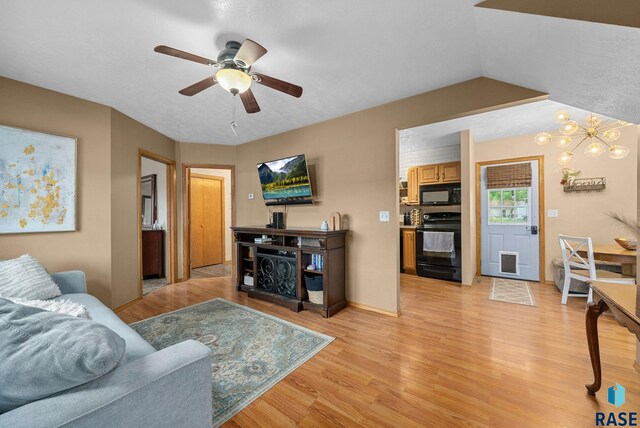 308 W 5th Ave, Lennox, SD 57039 - living area featuring light wood finished floors, ceiling fan, and a chandelier