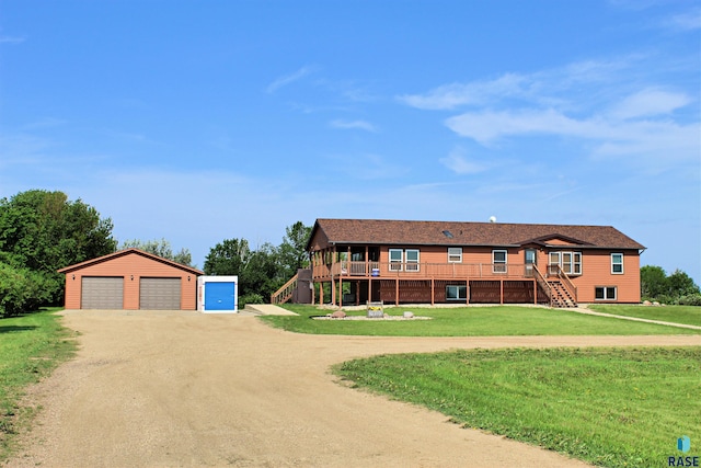 27549 475th Ave, Worthing, SD 57077 - view of front of house featuring stairway, an outdoor structure, dirt driveway, and a detached garage