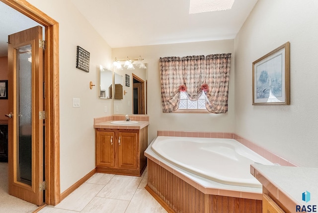 27549 475th Ave, Worthing, SD 57077 - bathroom with vanity, a garden tub, a skylight, and baseboards