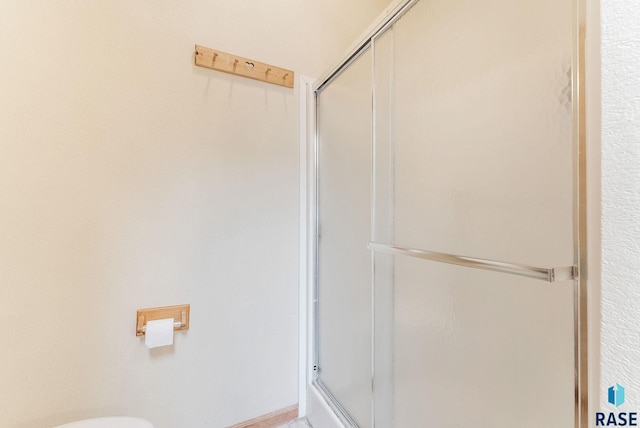 27549 475th Ave, Worthing, SD 57077 - full bathroom featuring a shower with door and toilet