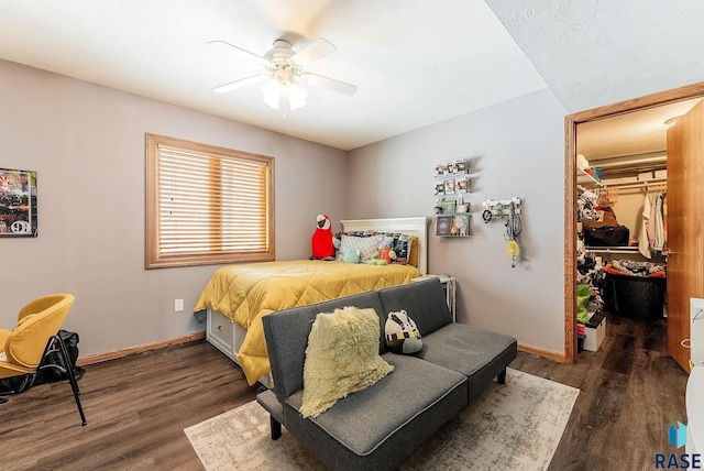27549 475th Ave, Worthing, SD 57077 - bedroom featuring wood finished floors, a spacious closet, baseboards, and a closet