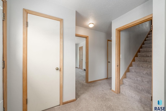 1422 E 17th St, Sioux Falls, SD 57104 - corridor with carpet flooring, stairs, baseboards, and a textured ceiling