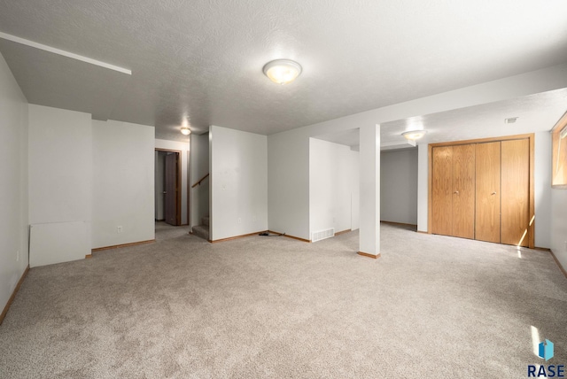 1422 E 17th St, Sioux Falls, SD 57104 - finished basement featuring stairway, light carpet, a textured ceiling, and baseboards