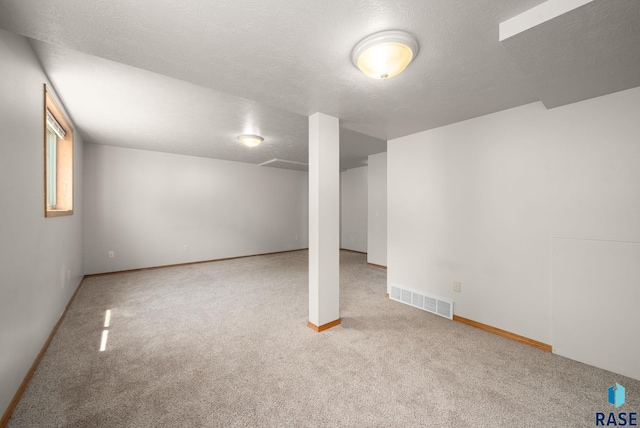 1422 E 17th St, Sioux Falls, SD 57104 - basement featuring carpet flooring, baseboards, and a textured ceiling