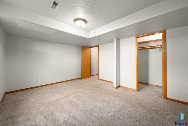 1422 E 17th St, Sioux Falls, SD 57104 - unfurnished bedroom with light carpet, baseboards, and a textured ceiling