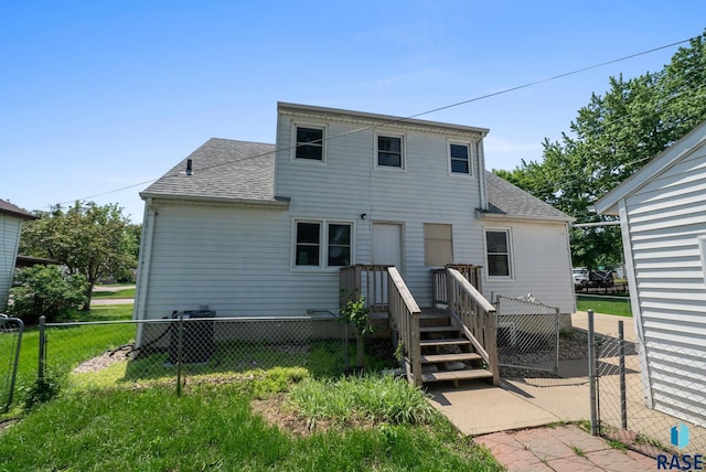 1422 E 17th St, Sioux Falls, SD 57104 - rear view of property with roof with shingles, central AC, and a wooden deck