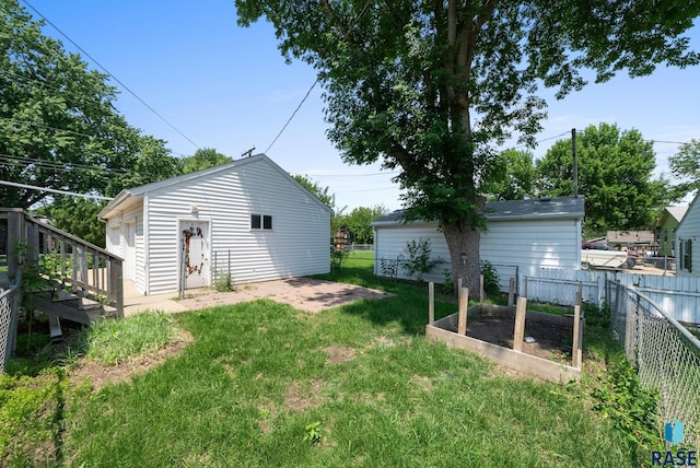 1422 E 17th St, Sioux Falls, SD 57104 - view of yard with a vegetable garden and an outbuilding