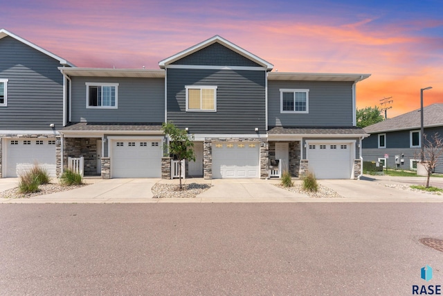 872 S Sycamore Ave Unit 3, Sioux Falls, SD 57110 - townhome / multi-family property featuring a garage, driveway, and stone siding
