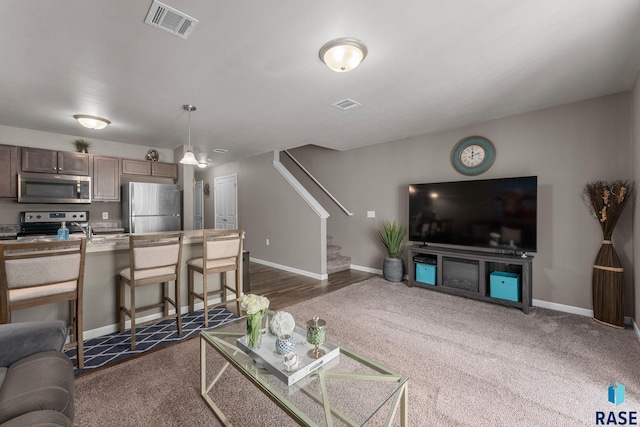 872 S Sycamore Ave Unit 3, Sioux Falls, SD 57110 - living area featuring stairway, dark colored carpet, and baseboards