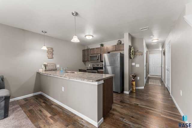 872 S Sycamore Ave Unit 3, Sioux Falls, SD 57110 - kitchen featuring appliances with stainless steel finishes, a peninsula, dark wood-type flooring, and a sink