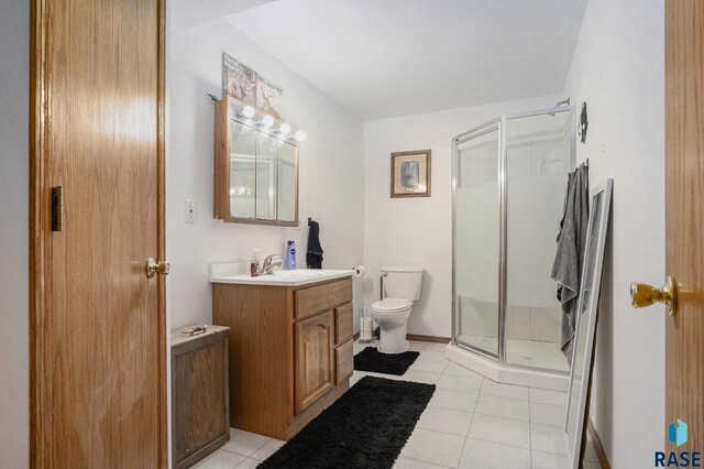 46687 276th St, Lennox, SD 57039 - full bath featuring vanity, toilet, a shower stall, and tile patterned flooring